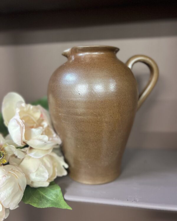 This lovely vintage pitcher is in great condition, it has a slightly metallic looking glaze to it. It has been handmade and would look really good displayed on a kitchen dresser or could be used as a vase for flowers.